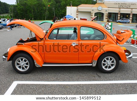 GLOUCESTER, VA- JULY 13: An orange VW Beetle in the (middle peninsula car club) blast from the past car show at the Main St shopping center in Gloucester, Virginia on July 13, 2013