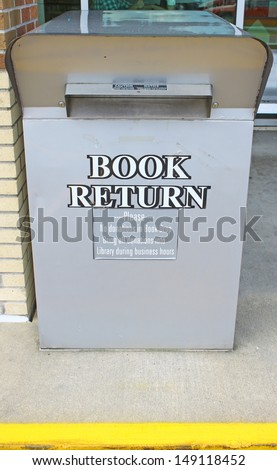 A drive up library book return bin/box outside the library