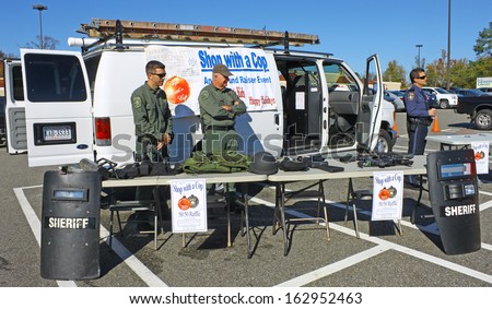 GLOUCESTER, VA- NOVEMBER 9: Gloucester County Sheriffs displaying their tools of the trade in the Shop with a Cop Car Show in Gloucester, Virginia on November 9, 2013