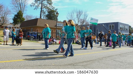 GLOUCESTER, VA - April 5, 2014: Riverside hospital and Sanders Retirement Village Staff walking in the parade, The Daffodil fest and Parade is a regular event held each spring