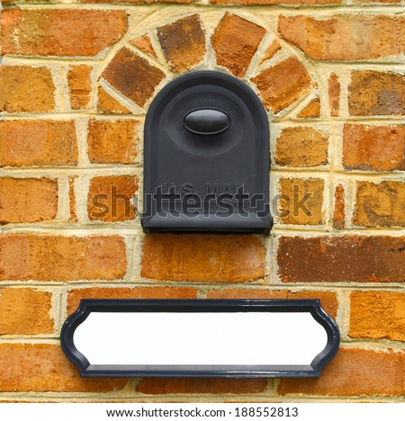A mailbox in a brick enclosure with an address/name plate for your use