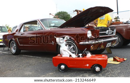 GLOUCESTER, VIRGINIA - AUGUST 23, 2014:A burgundy 1965 OZ mustang and tin man character in the DRIVE-IN FOR DIABETES CAR SHOW Sponsored by Tractor Supply in August in Gloucester Virginia.