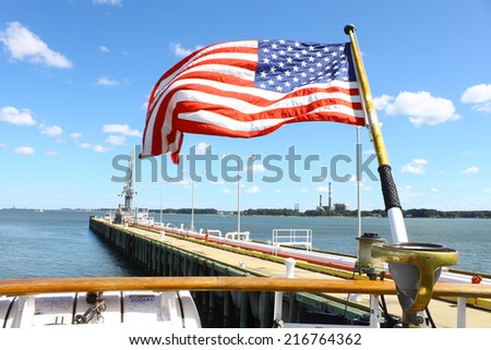 GLOUCESTER, VA - SEPTEMBER 6, 2014: The stern of USCGC Eagle with the American flag flying at the Yorktown Coast guard training center pier where it is tied up on the York river in Virginia