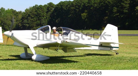 MIDDLESEX, VA - SEPTEMBER 27, 2014: A small white personal aircraft/airplane in  the wings wheels and keels annual show at the Hummel airfield airstrip in Middlesex VA