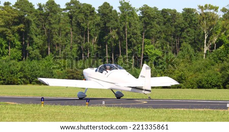 MIDDLESEX, VA - SEPTEMBER 27, 2014: A small white private plane at the runway at Hummel field in the wings wheels and keels annual show at the Hummel airfield airstrip in Middlesex VA