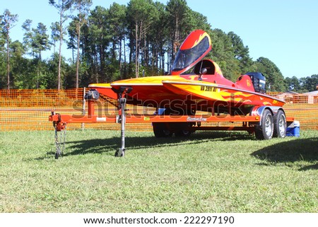 MIDDLESEX, VA - SEPTEMBER 27, 2014: A drag boat/speed boat on a trailer at hummel field airport runway in the wings wheels and keels annual show at the Hummel airfield airstrip in Middlesex VA