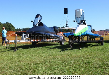 MIDDLESEX, VA - SEPTEMBER 27, 2014: Two drag boats/speed boats on trailers at hummel field airport runway in the wings wheels and keels annual show at the Hummel airfield airstrip in Middlesex VA