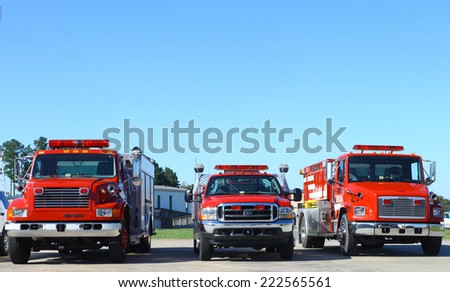 MIDDLESEX, VA - SEPTEMBER 27, 2014: Three Fire Trucks lined up at hummel field airport runway in the wings wheels and keels annual show at the Hummel airfield airstrip in Middlesex VA