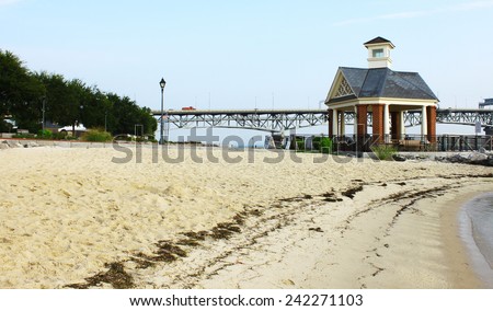 The Yorktown beach and waterfront with the Coleman bridge and a small gazebo type of building in the background on a summer day