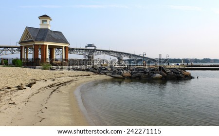 The Yorktown beach and waterfront with the Coleman bridge and a small gazebo type of building in the background on a summer day