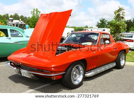 WILLIAMSBURG, VA - May 9, 2015: An old classic red Chevy Corvette with sidepipes at the 6th Annual Project Lifesaver Car Show in Williamsburg Virginia on a summer day.