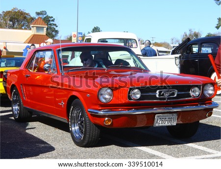 GLOUCESTER, VIRGINIA - NOVEMBER 14, 2015: A red 1965 Ford Mustang in the annual Shop With a Cop Car Show held once each year to help benefit needy children of Gloucester for Christmas.