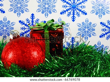 A Christmas holiday season design using a christmas ball and present with room for your text using selective focus.