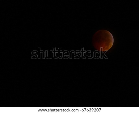GLOUCESTER - DECEMBER, 21: A Historical Lunar Eclipse coinciding with the Winter Solstice as seen through the clouds in  the night sky on Dec. 21, 2010 in Gloucester Virginia