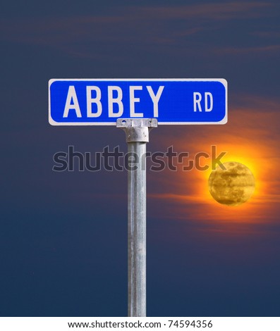 An Abbey road sign against a fire glowing moon using selective focus and a shallow depth of field with room for your text.