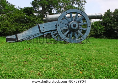 An old Civil War canon sitting on the grass field where it once protected and guarded Yorktown Virginia during the Civil War with room for your text.