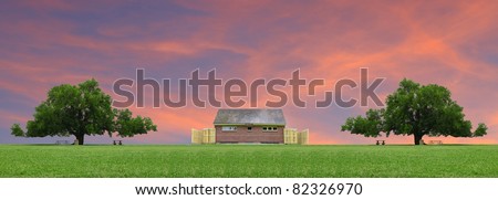 A pair of large oak tress besides an outdoor public restroom facility at a park field with a gorgeous sunset in the clouds behind them