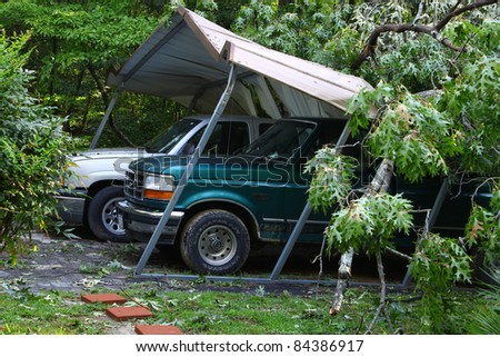 GLOUCESTER, VA, USA - AUGUST 28: Hurricane Irene damage to two trucks crushed by a fallen tree in the northern Ark locality of Gloucester VA.August 28, 2011 in Gloucester, VA, USA