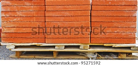 A pallet full of red landscape bricks for patio\'s and walkways with room for your text.