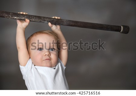 Little strong baby toddler playing sports. Kid during his workout. Success and winner concept
