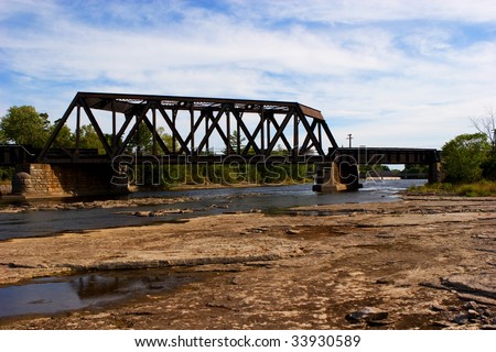 a Railroad bridge overlooking an almost dry riverbed of the Moira River in Ontario, Canada