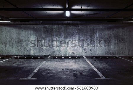 Urban underground background. Concrete wall under the lamp light in the dark.