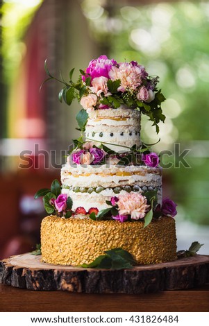 fruit wedding cake with flowers on a cut tree