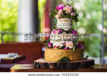 fruit wedding cake with flowers on a cut tree