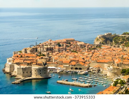 The picturesque landscape of the old town of Dubrovnik (Croatia) and the Adriatic sea with many boats, from above. Dubrovnik is part of the UNESCO World Heritage Site.