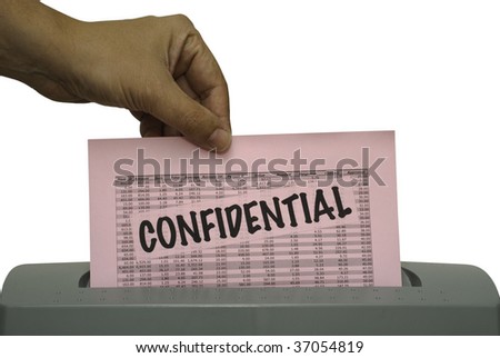 Male hand, feeding a pink piece of paper with the word confidential and random numbers into a shredder. Saved including clipping path.