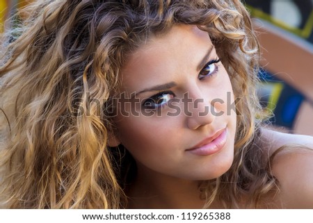 Beautiful blond Caucasian girl portrait against a colorful graffiti background