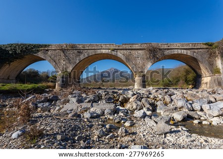 Old vintage stone bridge over Karnionas (or Xerilas) river near Leontari village in Arcadia, Greece.  The bridge was built in 1890 and it is used until today