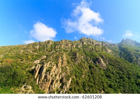 Green mountain peak reaching the skies in mount Athos