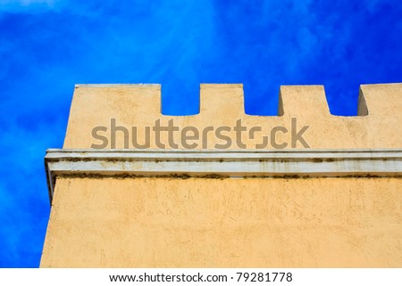 Typical Tower-house detail in Greece against blue sky in the afternoon
