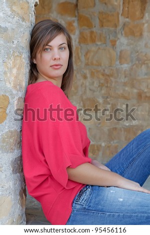 Young attractive woman posing, looking towards the camera, side shot