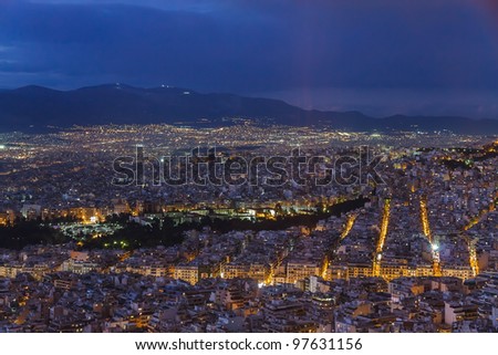 Athens skyline aerial view in the afternoon with the lights over blue hour