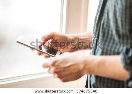 man holding mobile phone, mobile phone close-up,  using mobile phone, smart phone, cell phone in hands, white mobile phone