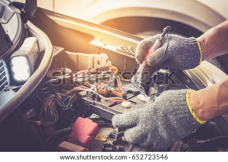 Mechanic repairs car in a car repair station