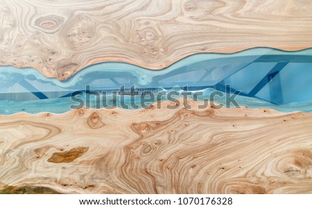Texture of a wooden table with epoxy resin. Top view of wood for background