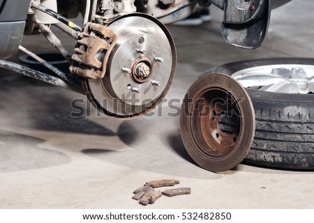 brake disc. Replacement of the old to the new. Auto mechanic repairing .