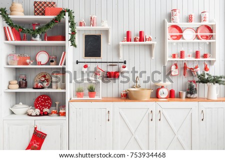 Interior light grey kitchen and red christmas decor. Preparing lunch at home on the kitchen concept