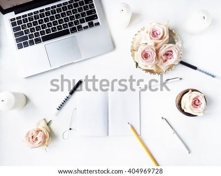 Workspace with pen, pencil, laptop, pink rose flower, golden vintage tray, candle on white background. Flat lay, top view