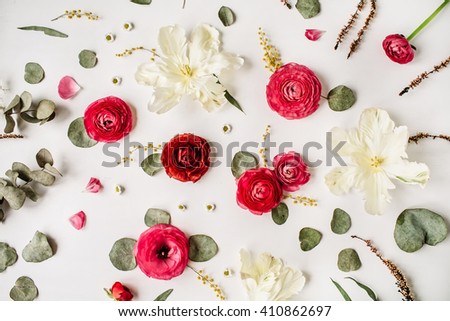 Pattern with pink and red roses or ranunculus, white tulips and green leaves on white background. Flat lay, top view