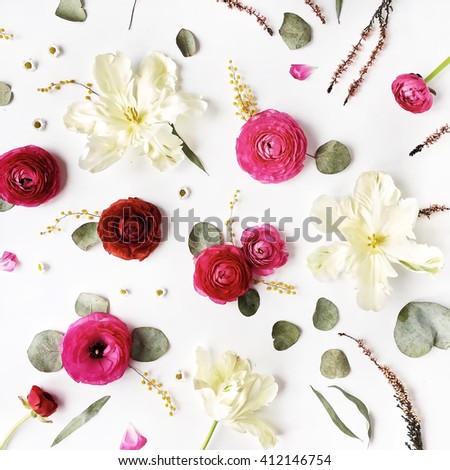Pattern with pink and red roses or ranunculus, white tulips and green leaves on white background. Flat lay, top view