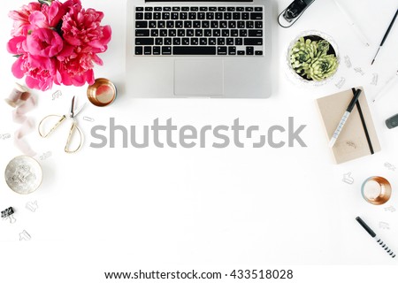 Flat lay, top view office table desk. Workplace with laptop, succulent, peonies, golden scissors, spool with beige ribbon, pencils and diary.