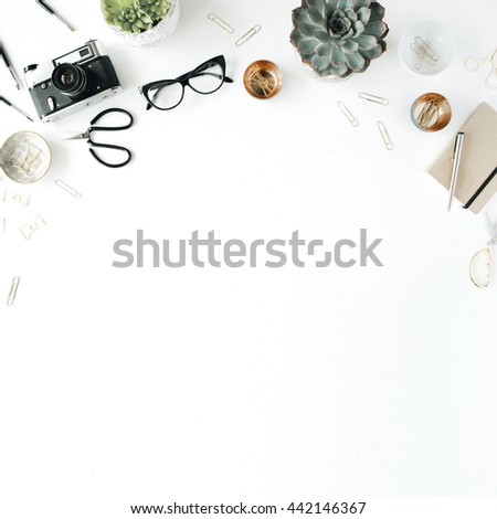 feminini desk workspace with succulent, retro camera, scissors, diary, glasses and golden clips on white background. flat lay, top view