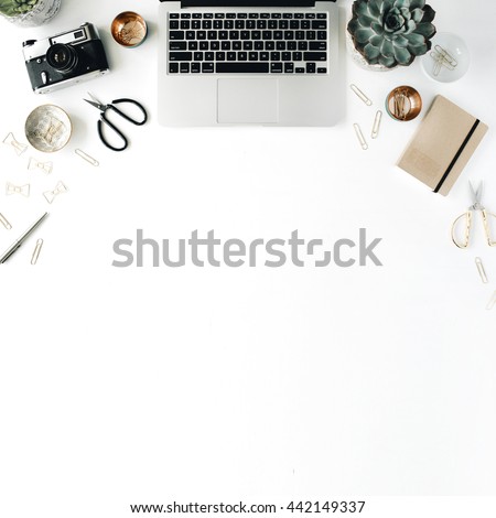 feminini desk workspace with succulent, laptop, retro camera, scissors, diary and golden clips on white background. flat lay, top view