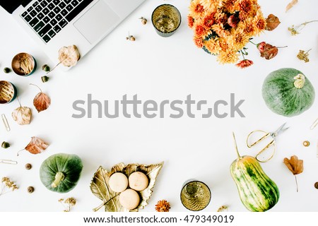autumn fall flat lay, top view home office table desk. workspace with laptop, chrysanthemum bouquet, pumpkin, leaves, scissors on white background, flat lay, top view