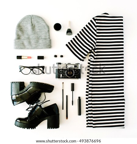 female autumn and winter clothes collage with retro camera, accessories and cosmetics on white, flat lay, top view