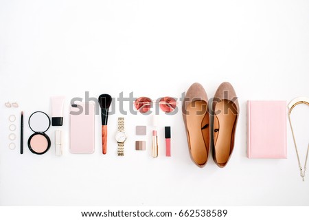 Beauty blog fashion concept. Female pink styled accessories: cell phone, watches, sunglasses, notebook, cosmetics, shoes on white background. Flat lay, top view trendy feminine background.